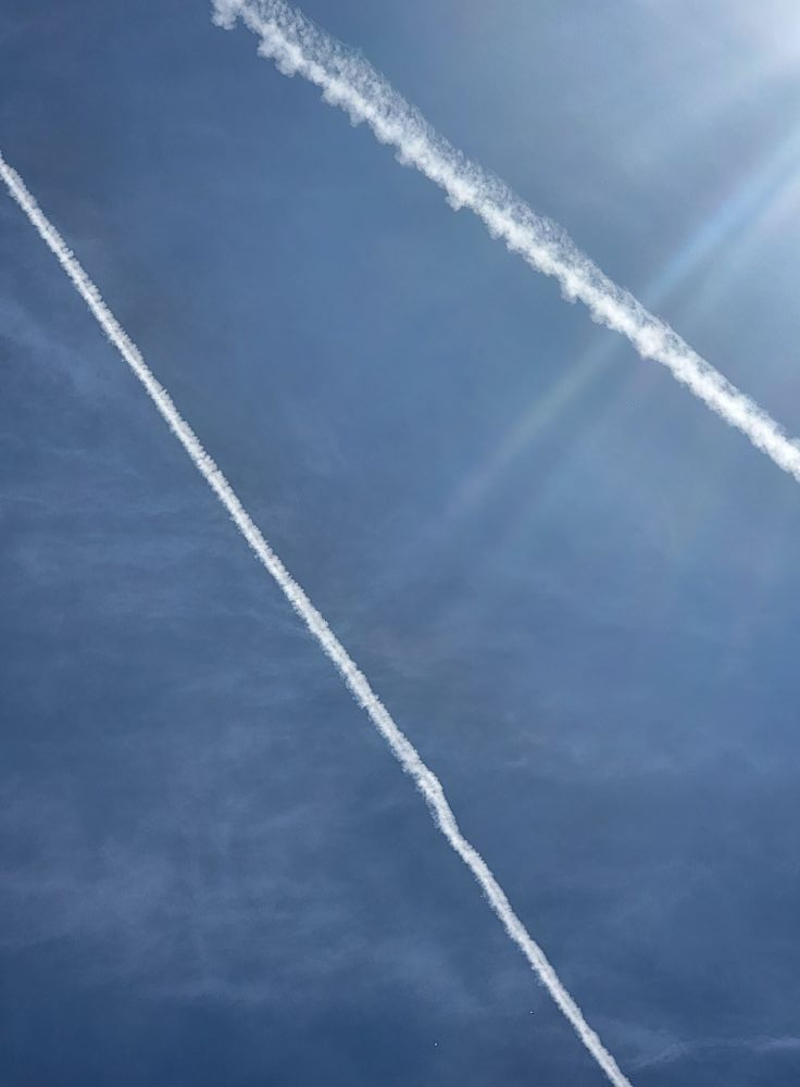 Multiple contrails crossing the sky